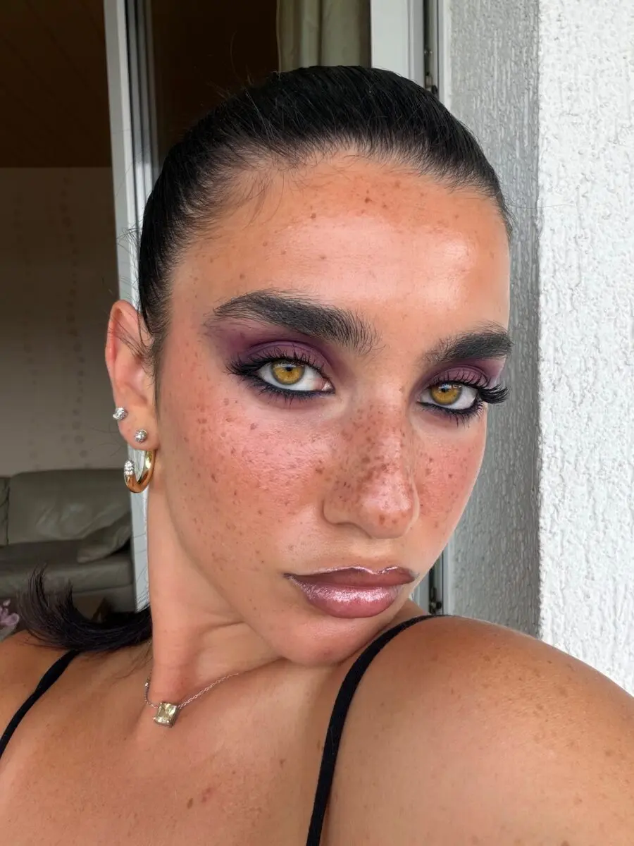 Bold baddie makeup with striking purple tones