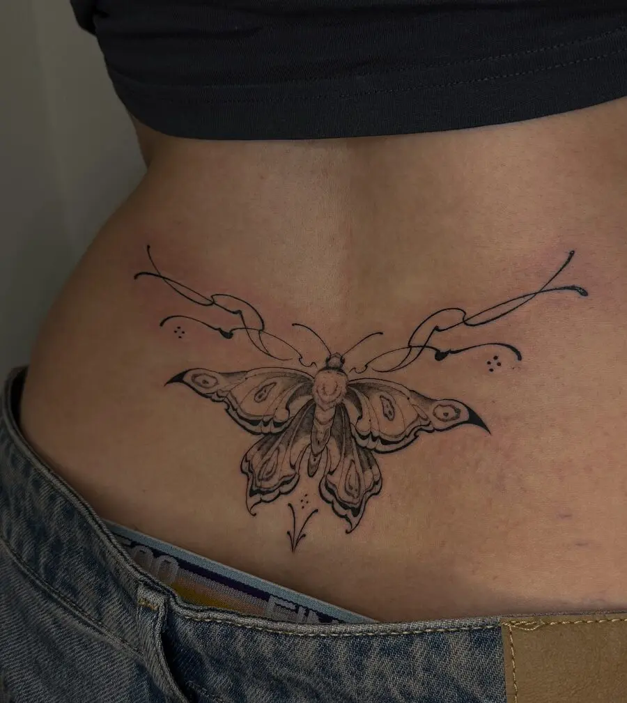 Elegant butterfly tattoo gracing the lower back