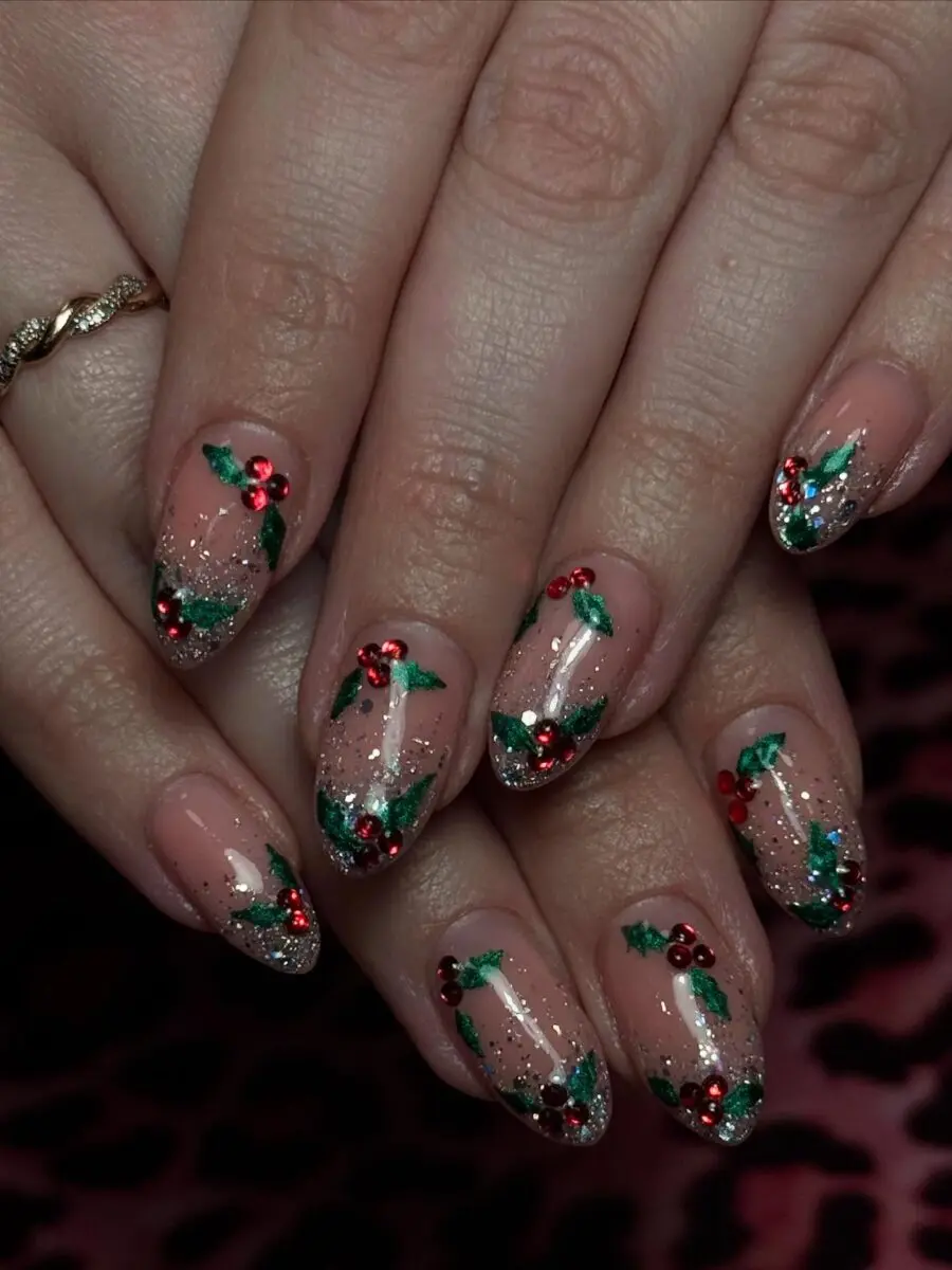 Festive nails featuring holly and glitter accents