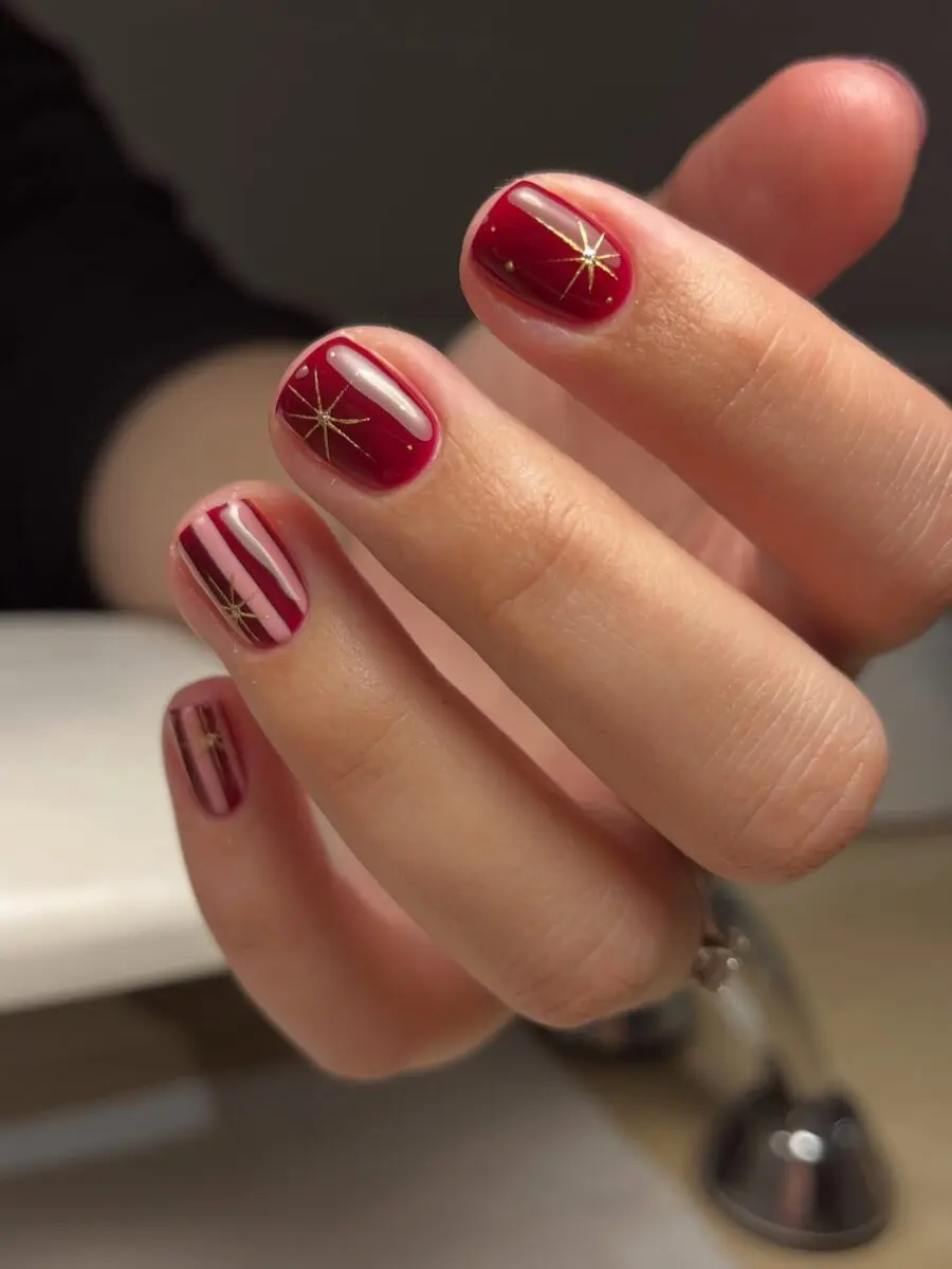 Stylish Red Nails with Gold Star Accents