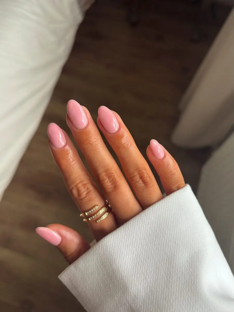 Glossy pink almond-shaped nails shine brightly