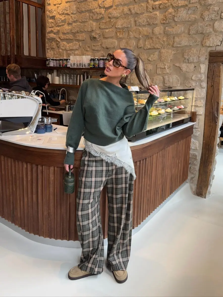 Chic green sweater paired with plaid pants
