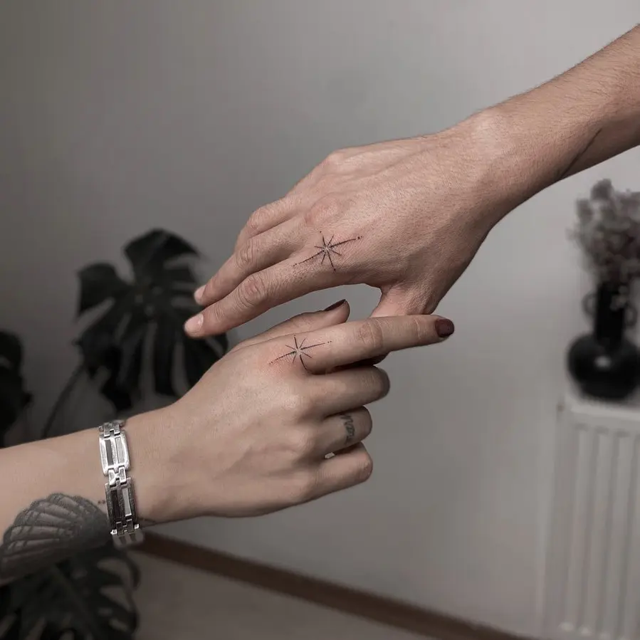 Couple tattoos symbolizing direction and unity