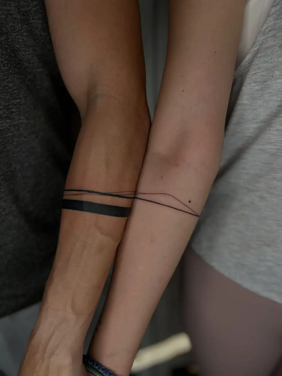Minimalistic couple tattoos symbolizing connection