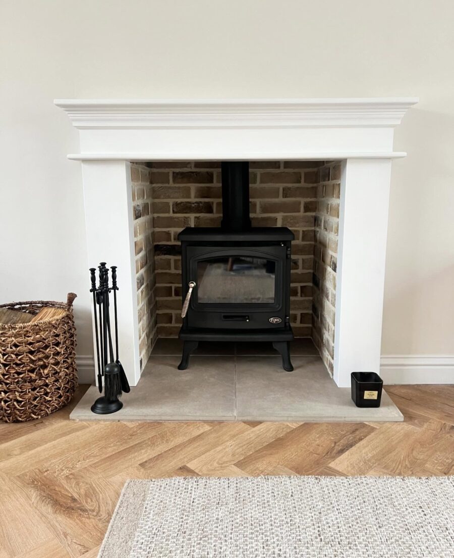 Charming black stove in a stylish white surround