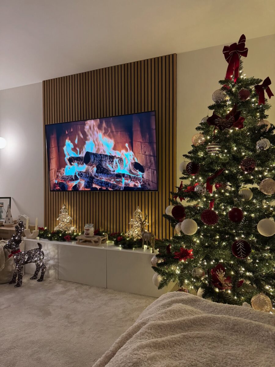 Elegant Christmas tree with a warm fireplace glow