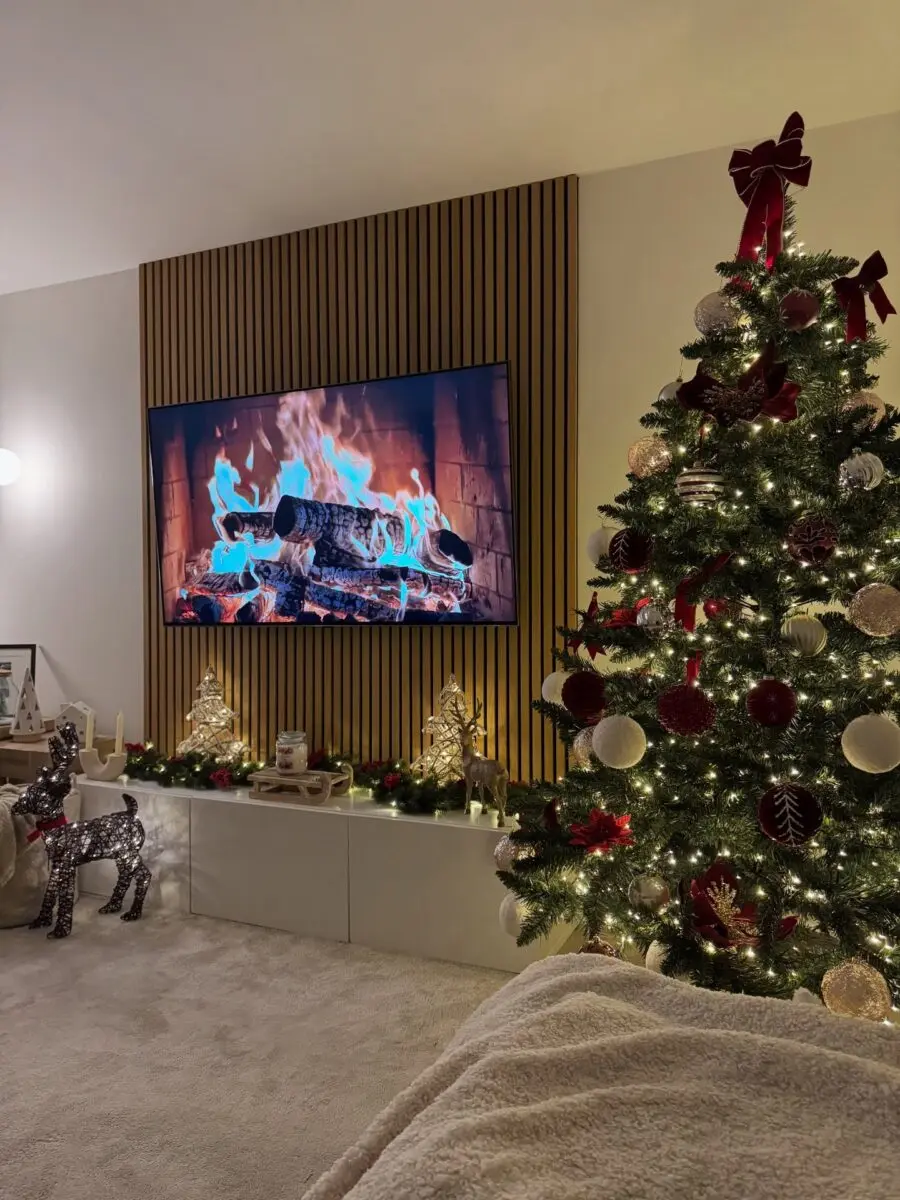 Elegant Christmas tree with a warm fireplace glow