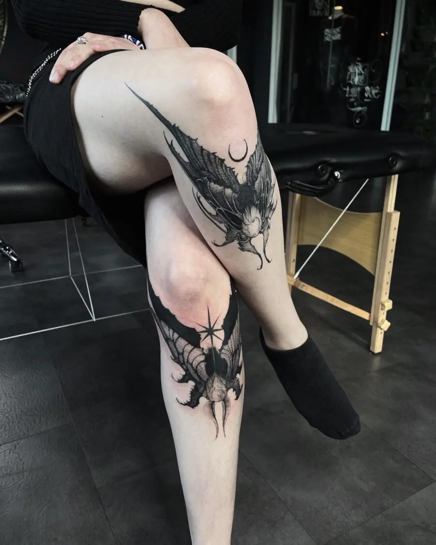 Intricate dark feminine bat tattoo on leg