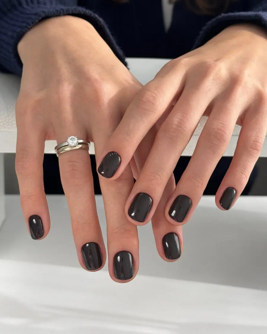 Chic dark feminine nail design with glossy finish