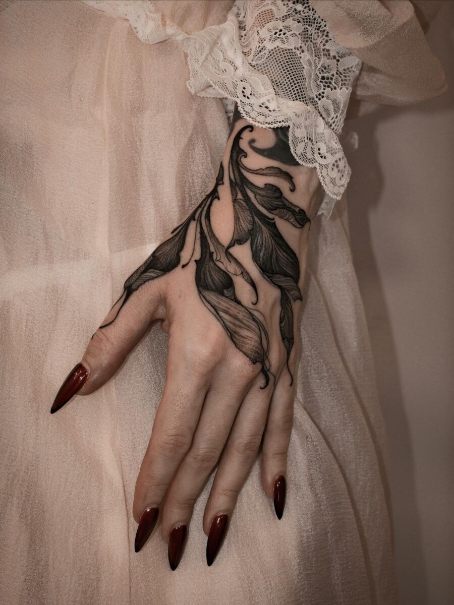Elegant floral design on feminine hand tattoo