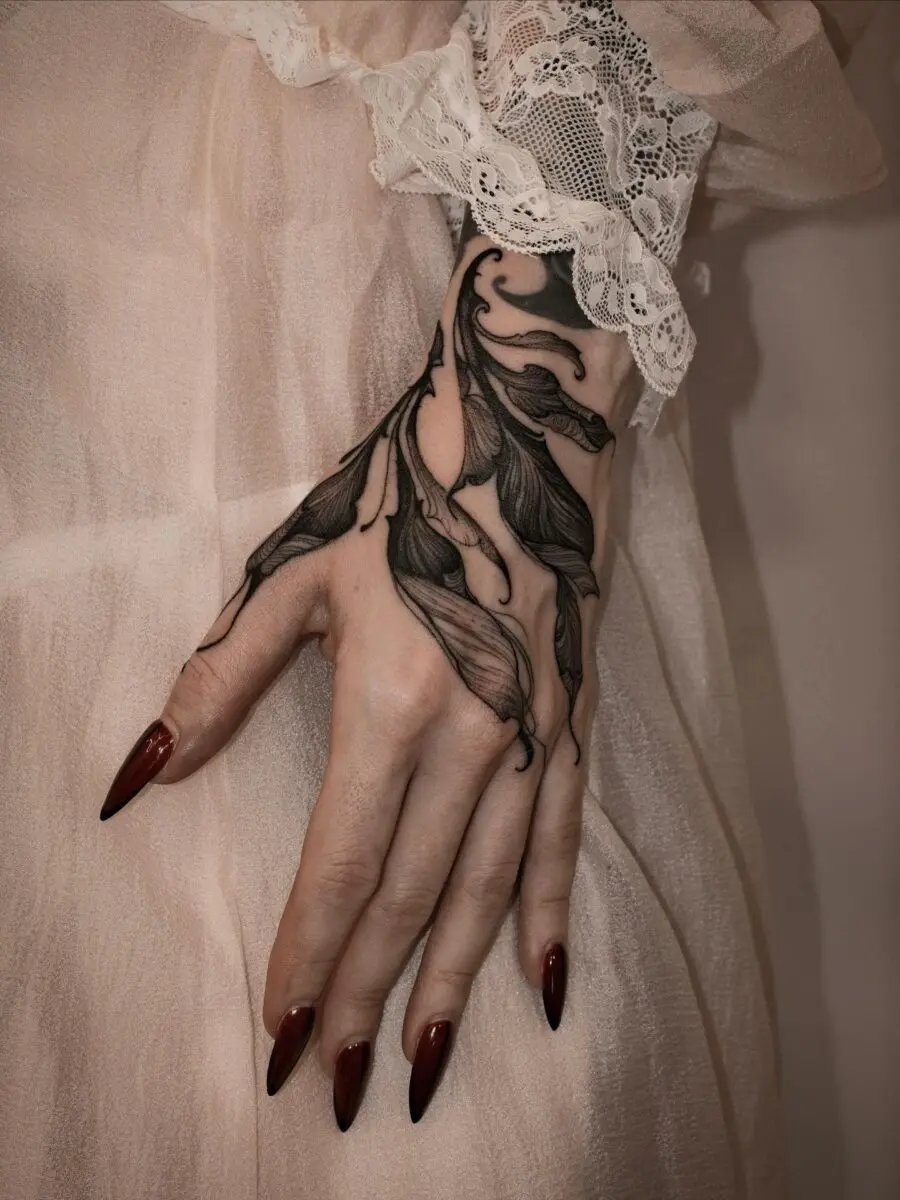 Elegant floral design on feminine hand tattoo