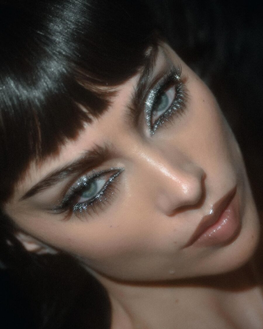 Striking dark feminine makeup with silver accents