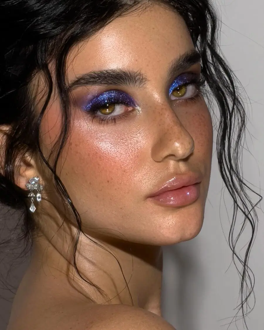 Radiant dark feminine look with bold shimmer