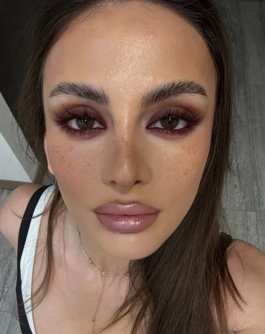 Bold dark eyes and soft nude lips shine