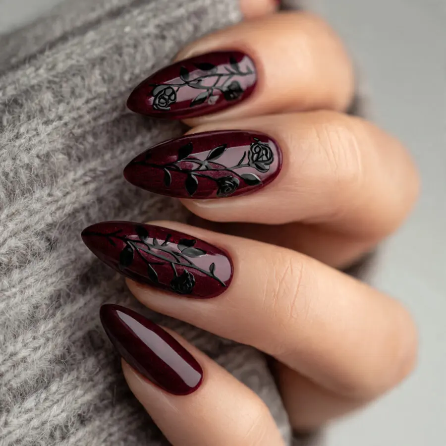 Elegant burgundy nails adorned with rose designs