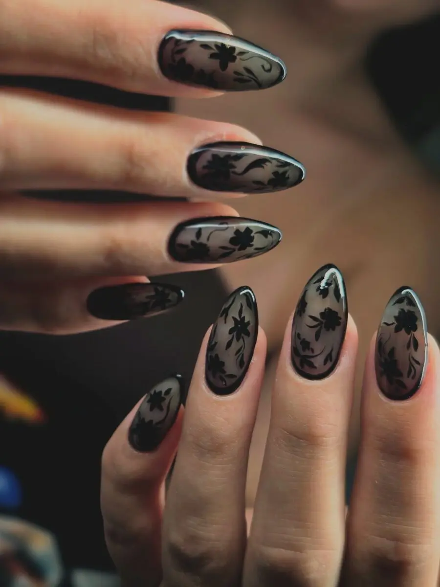 Elegant black floral designs on feminine nails
