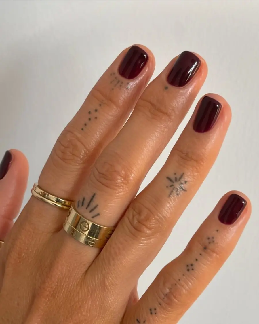 Elegant glossy burgundy nails exuding dark femininity.
