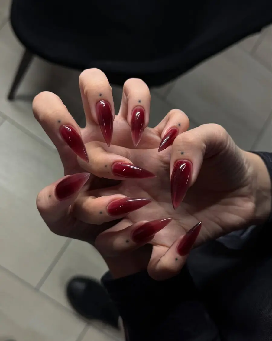 Bold red stiletto nails embody dark femininity