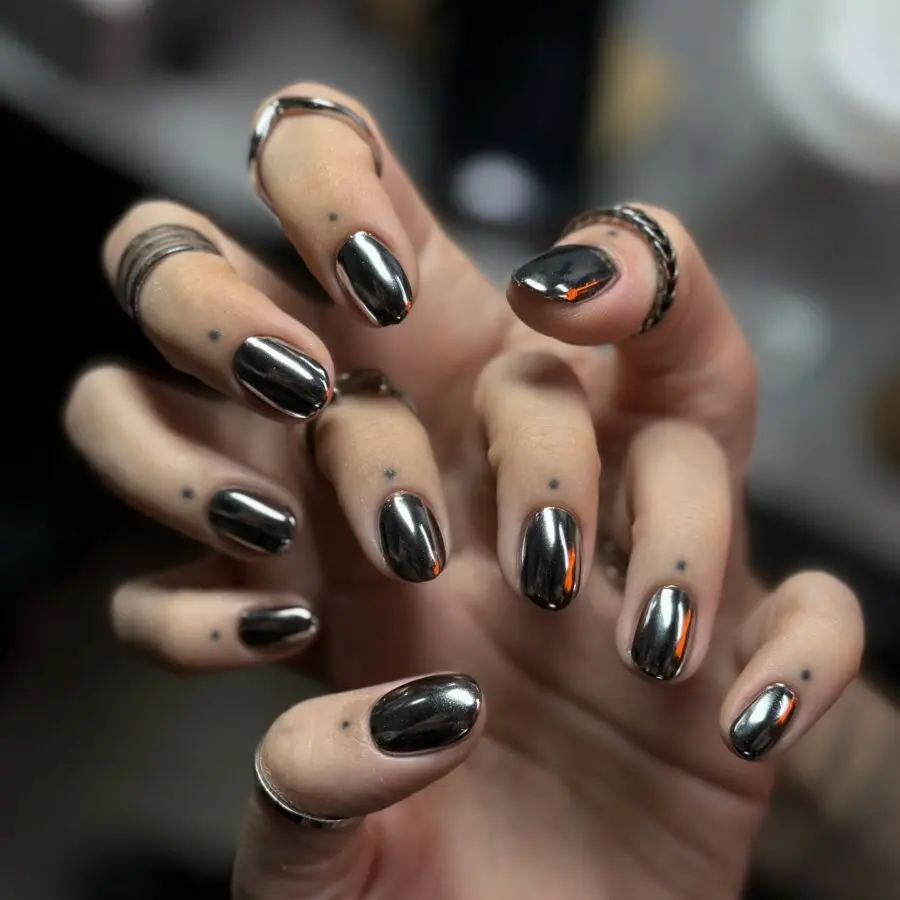 Stylish dark feminine nails with metallic sheen