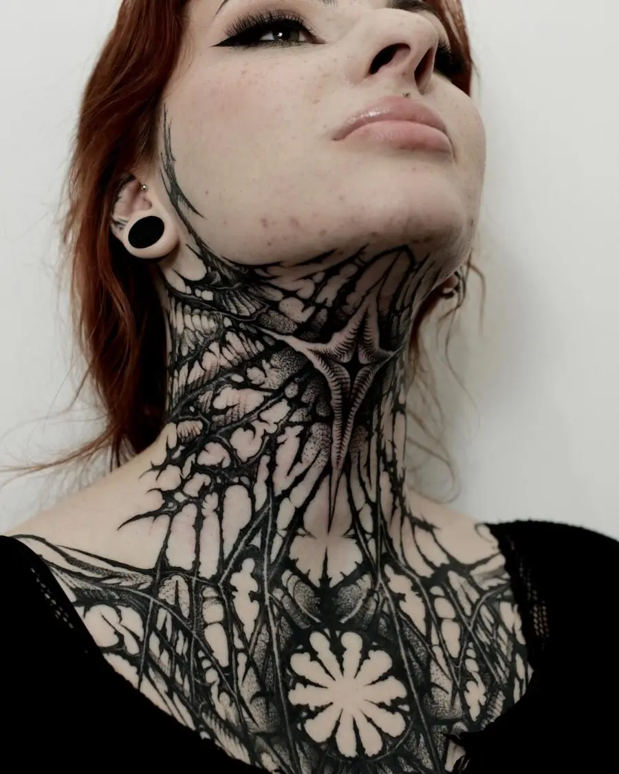Intricate neck tattoo embodying dark femininity