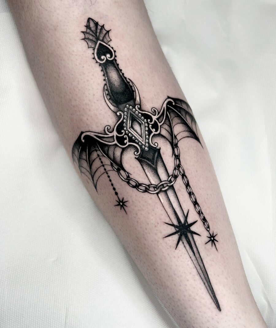 Intricate dagger tattoo with gothic elements