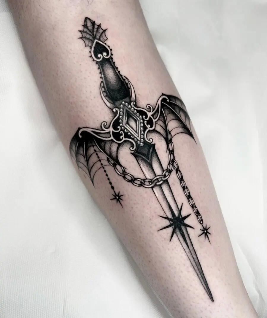 Intricate dagger tattoo with gothic elements