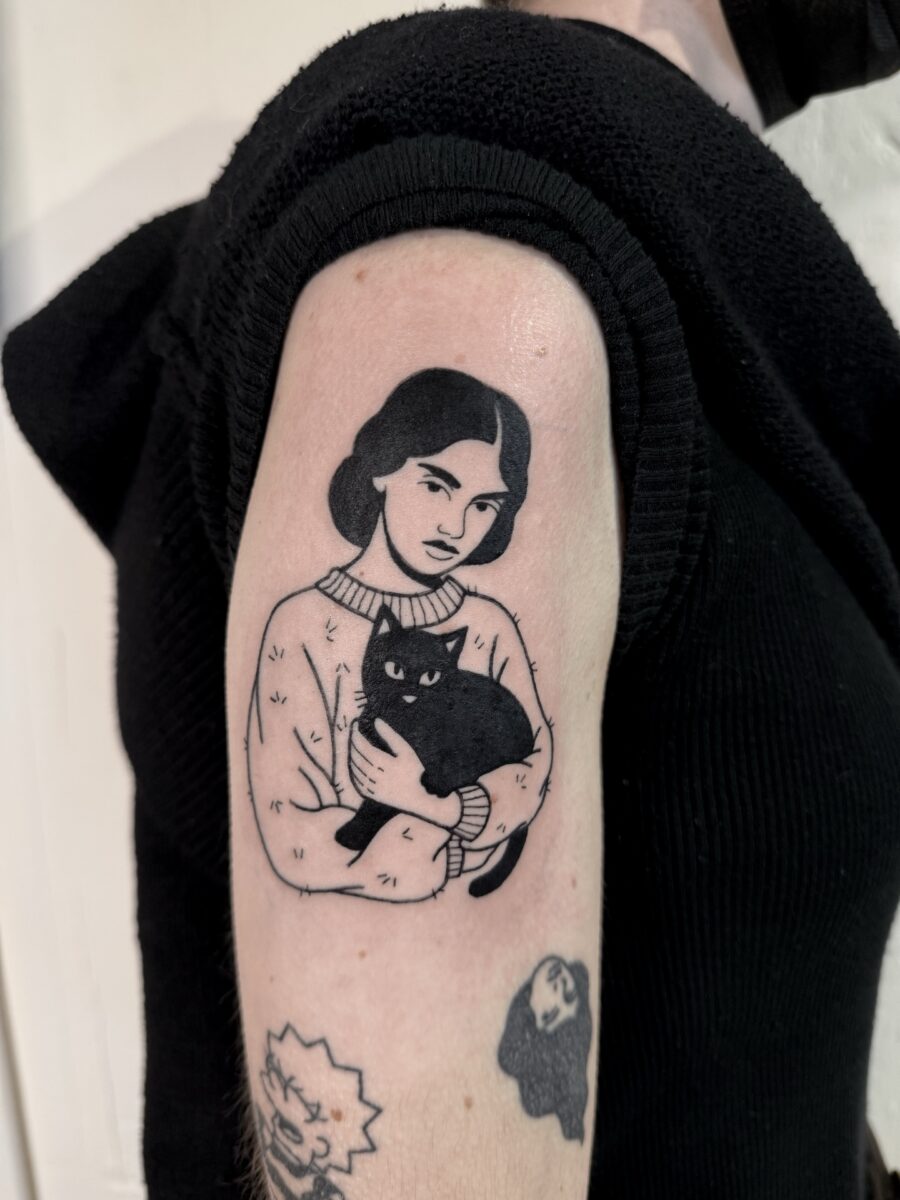 Intriguing woman with black cat tattoo
