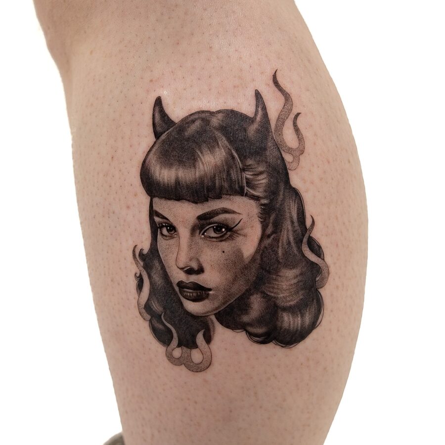 Intriguing dark feminine tattoo with devilish flair