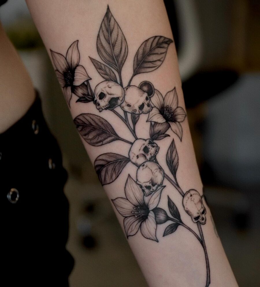 A hauntingly beautiful skull and flower tattoo