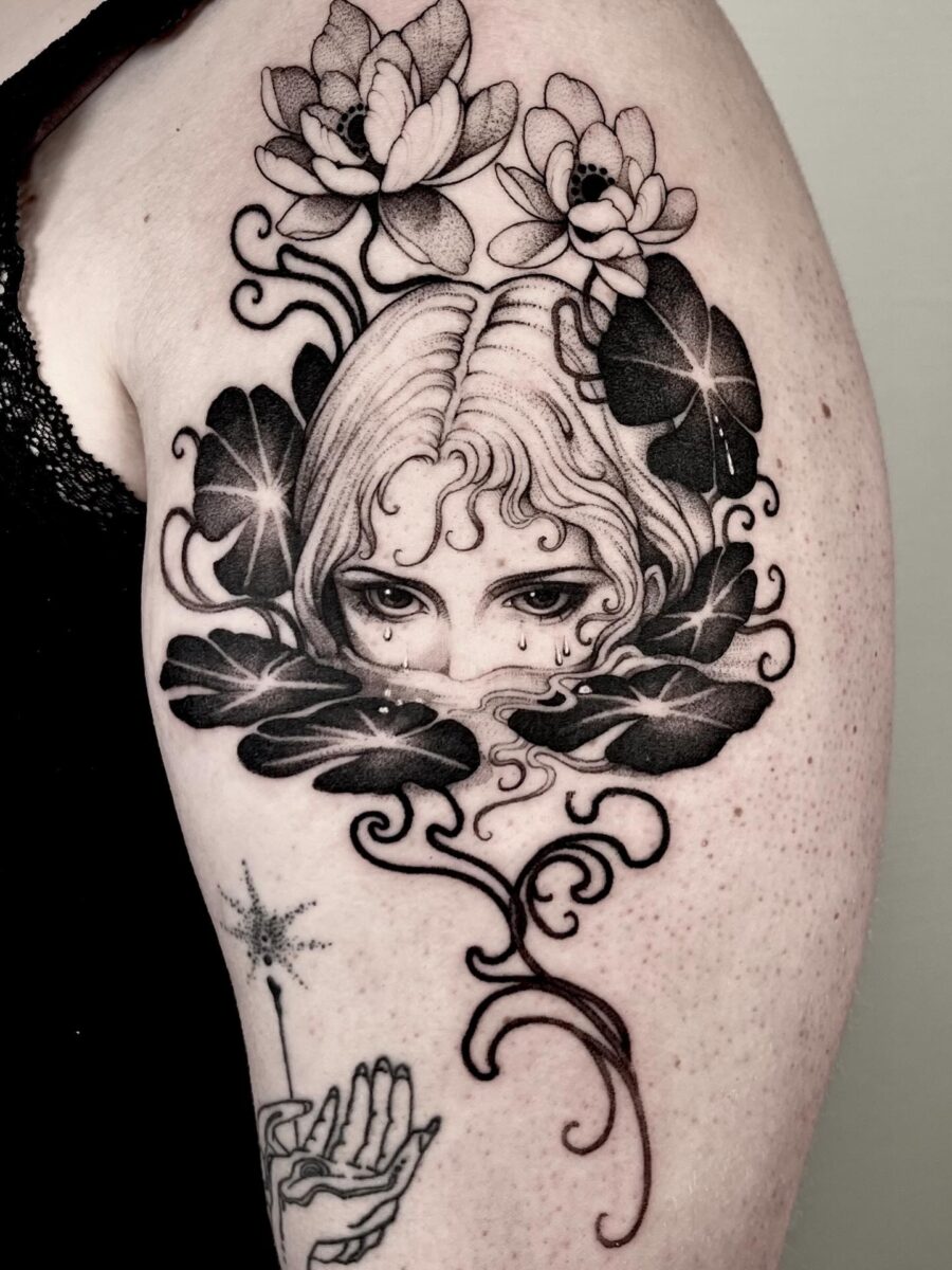 Mysterious feminine tattoo with floral elements