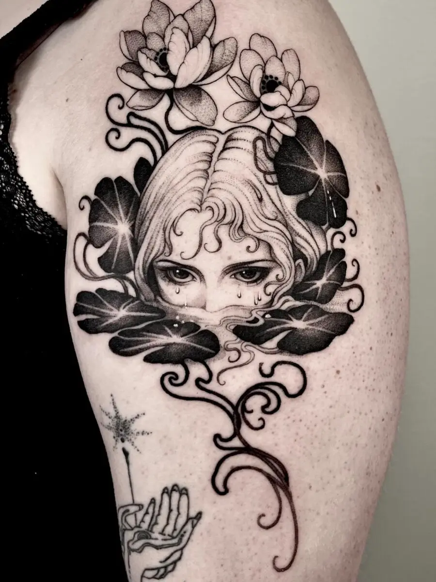 Mysterious feminine tattoo with floral elements