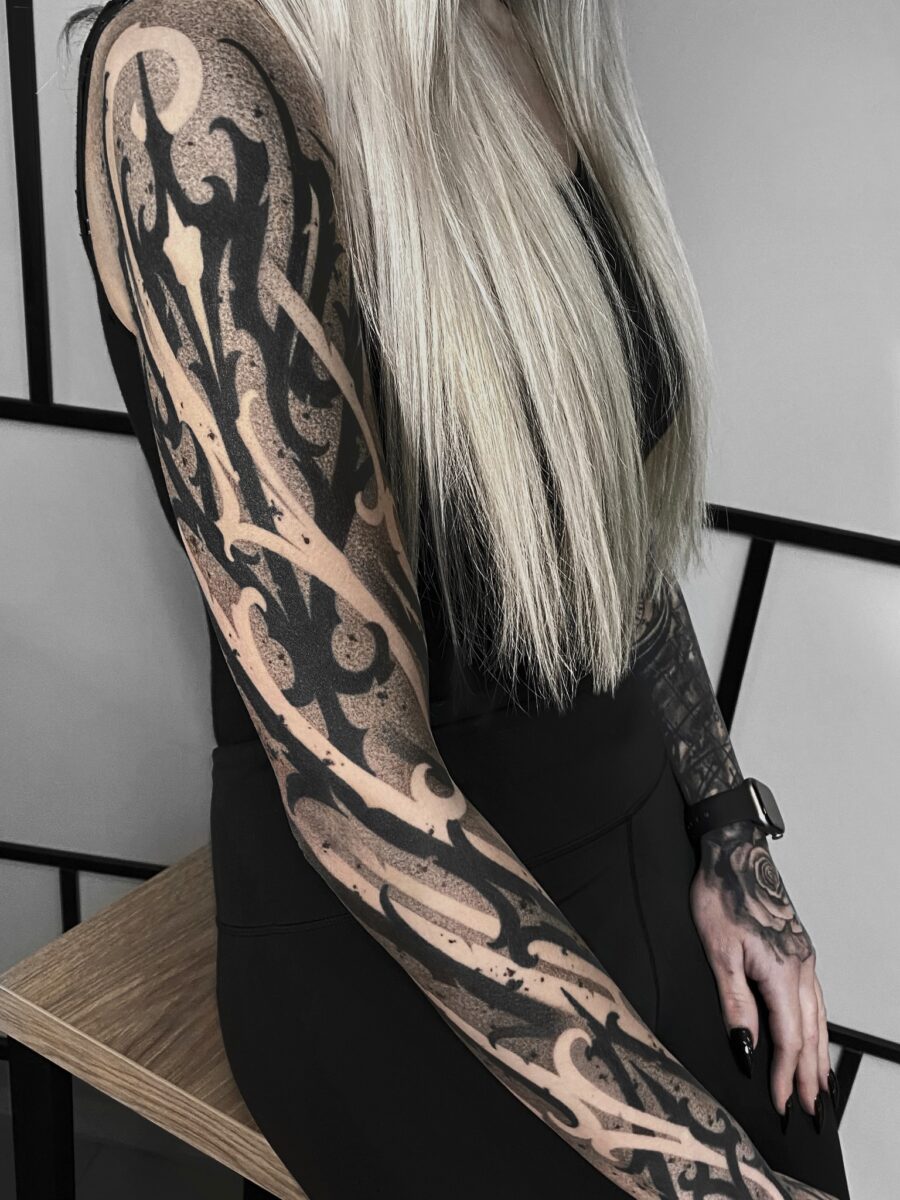 Intricate dark feminine tattoo sleeve in focus