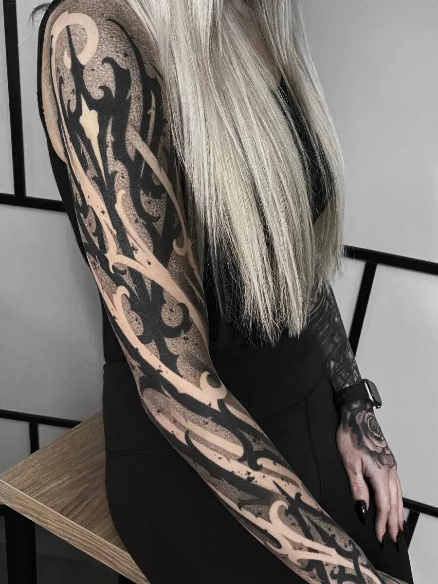 Intricate dark feminine tattoo sleeve in focus