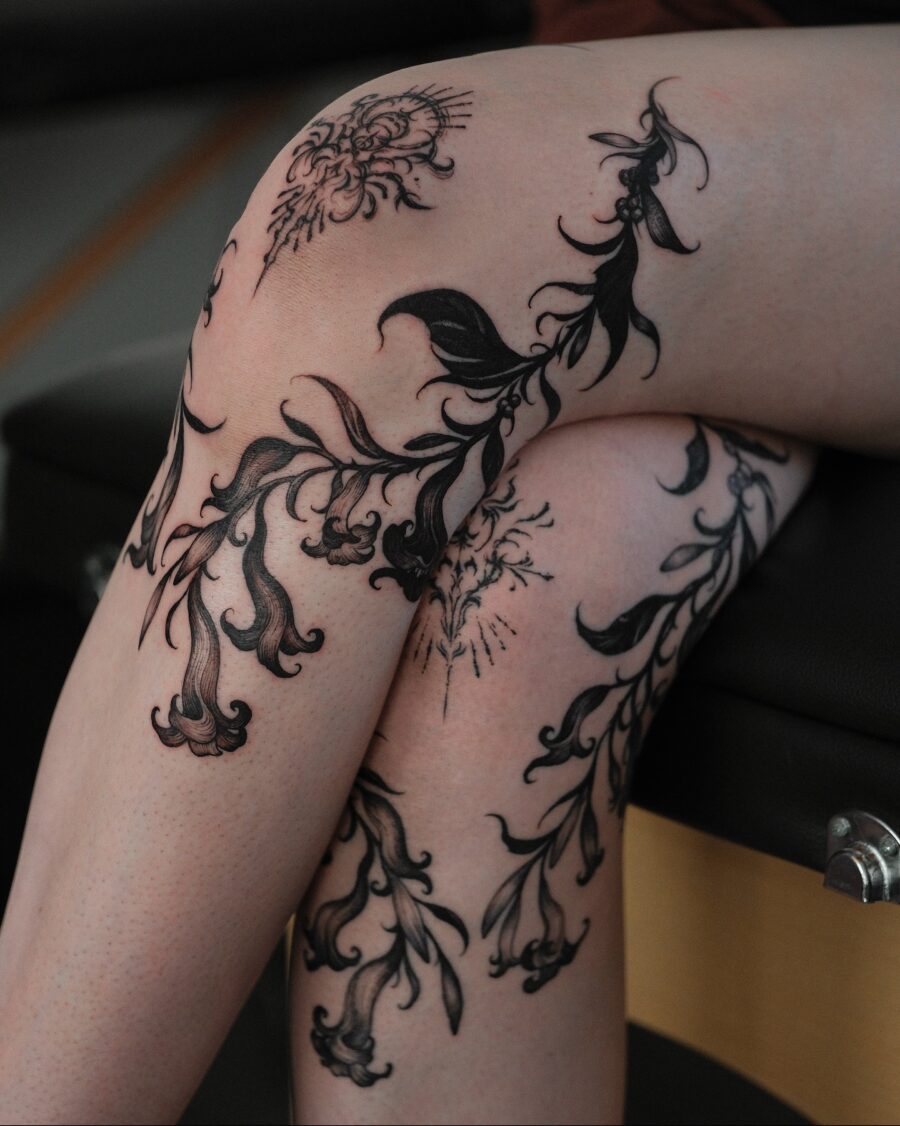Elegant floral ink designs on feminine legs