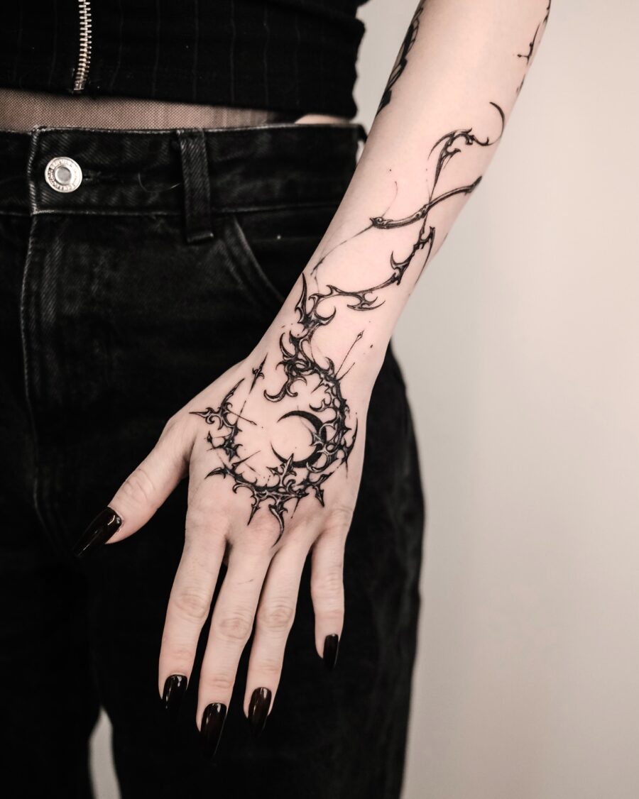 Intricate shadowy design adorns the hand