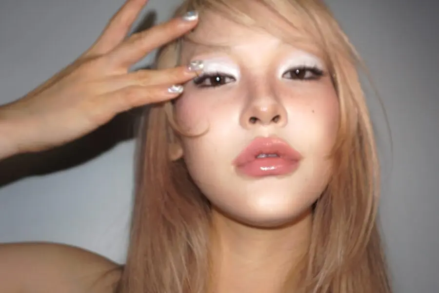 Glowing pink makeup with bold accents