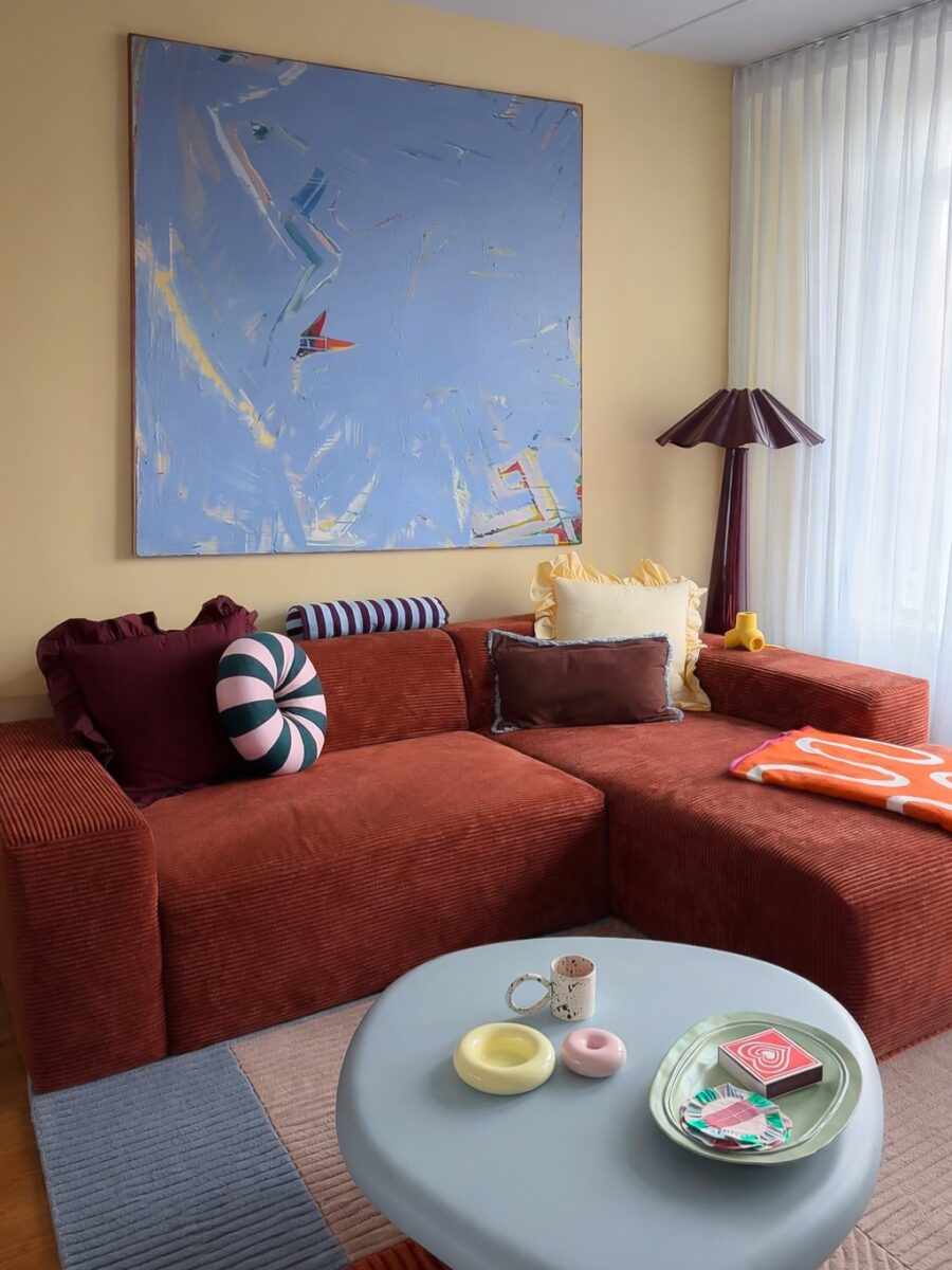 Vibrant couch paired with abstract wall art