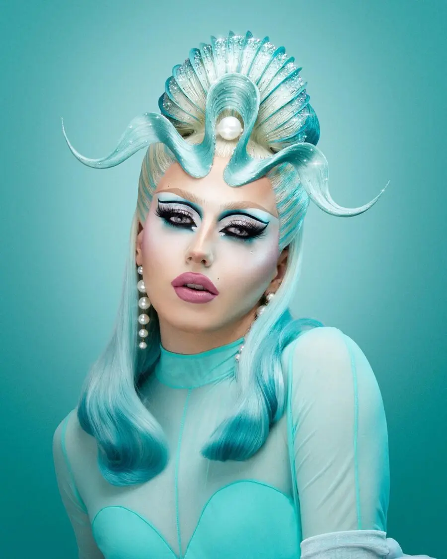 Glamorous aqua-inspired drag queen makeup look