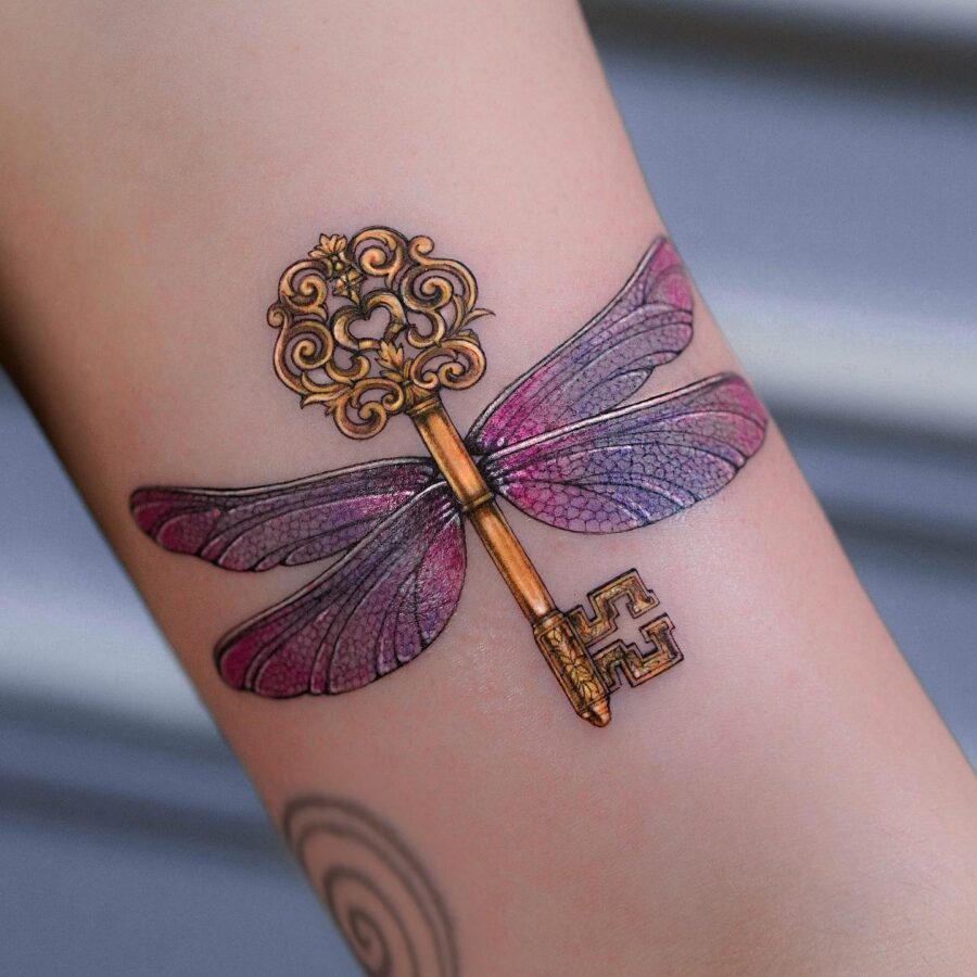 Stunning dragonfly key tattoo with vibrant colors