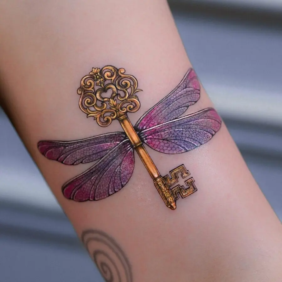 Stunning dragonfly key tattoo with vibrant colors