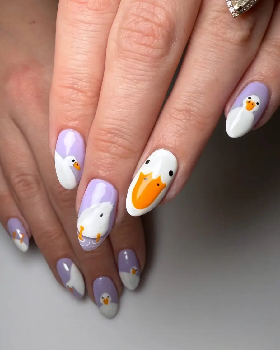Quirky duck-themed nail art in pastel hues