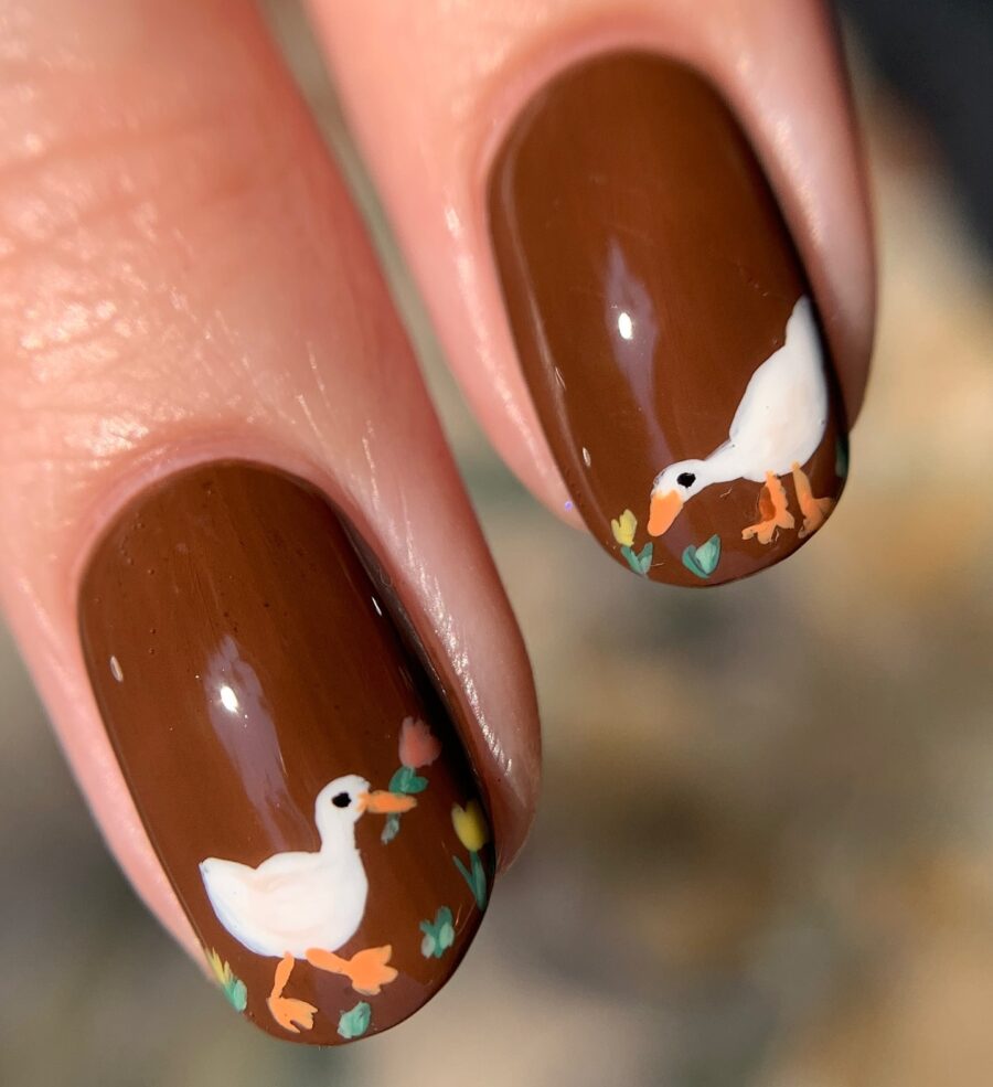 Charming duck nail art with floral accents