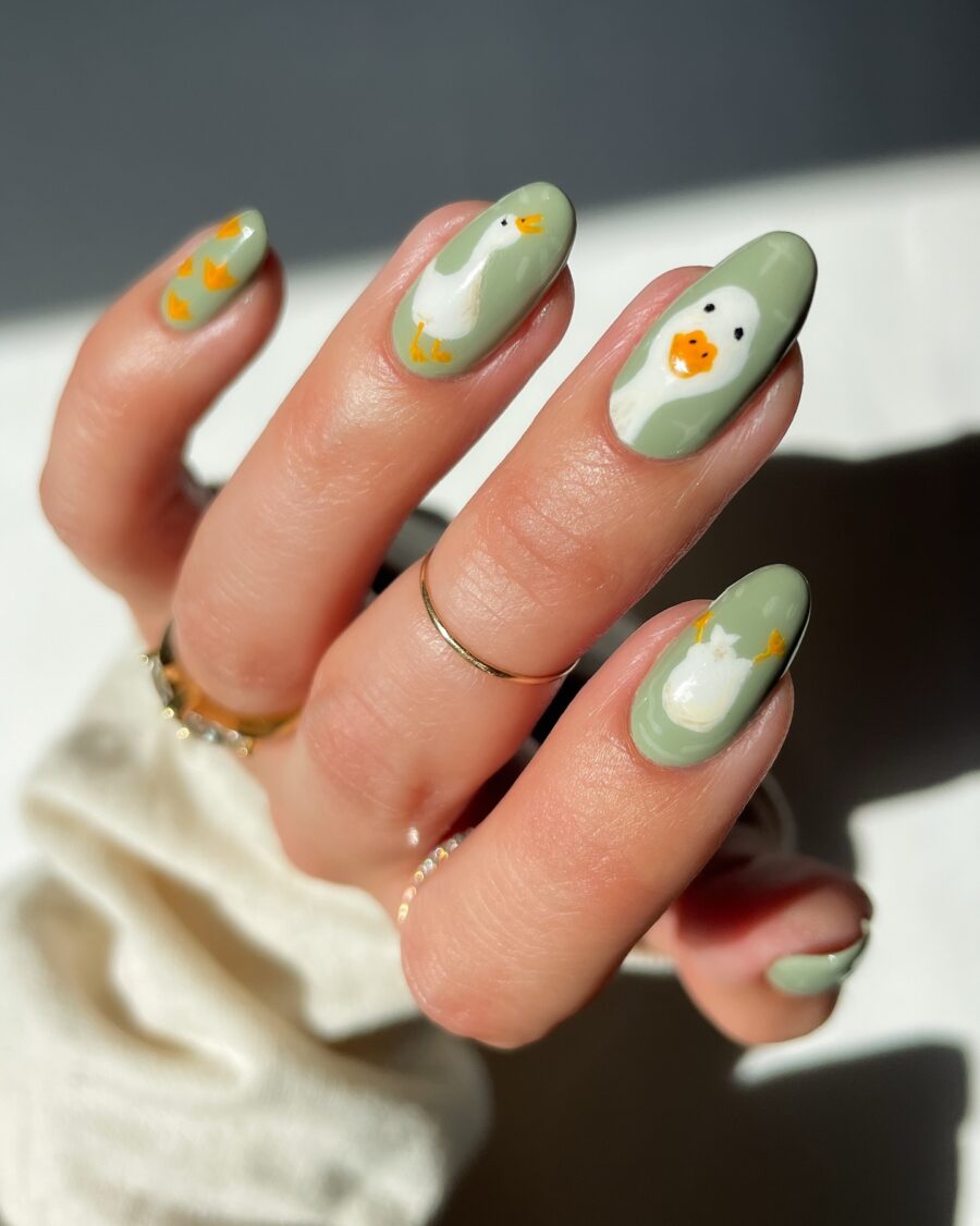 Charming green duck-themed nail art design