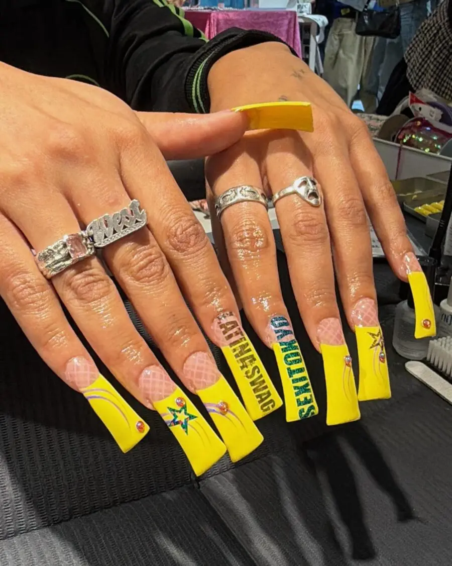 Vibrant yellow duck nails with unique designs
