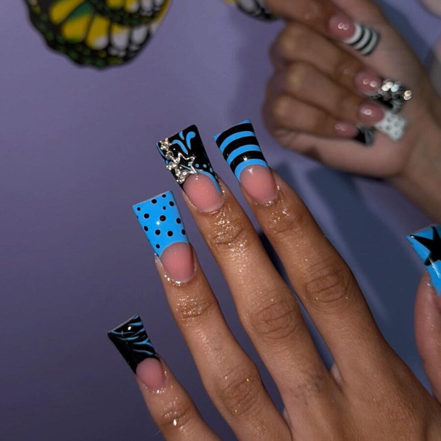 Vibrant blue duck nails with unique patterns