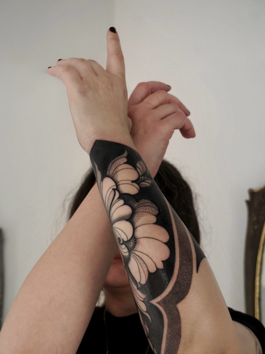 Bold floral tattoo exuding dark feminine vibes