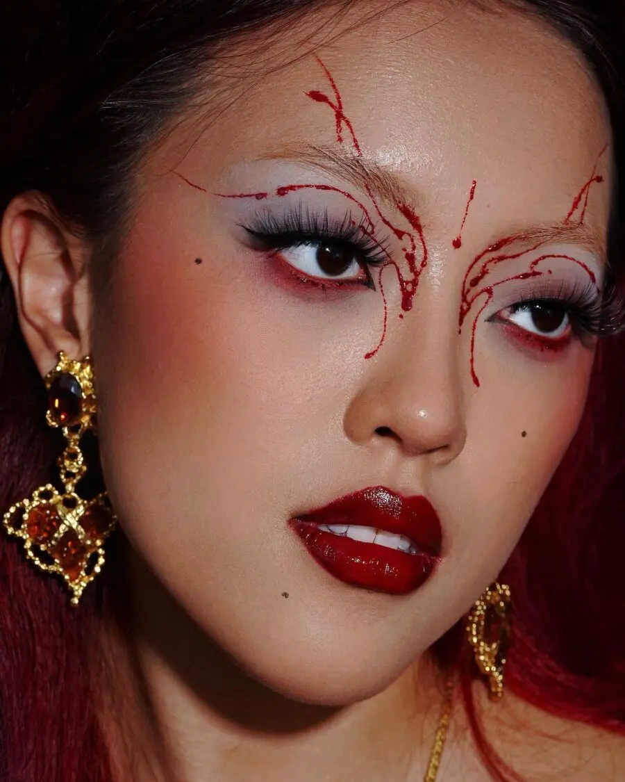Striking red and black emo makeup look
