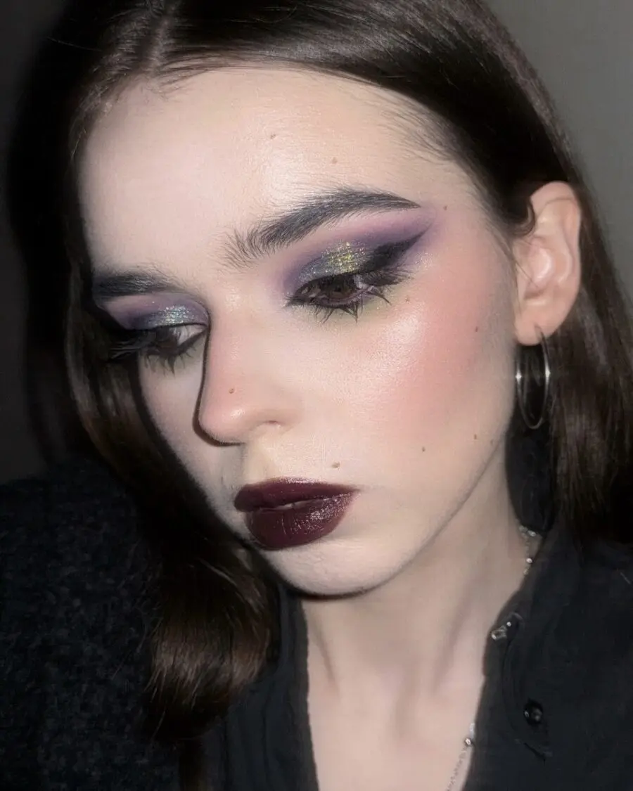 Bold emo makeup with dark and glittery vibes