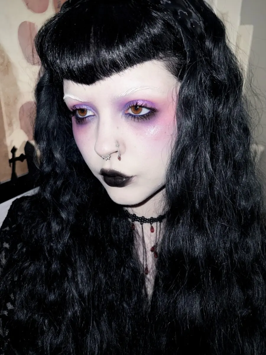 Striking purple and black emo makeup look