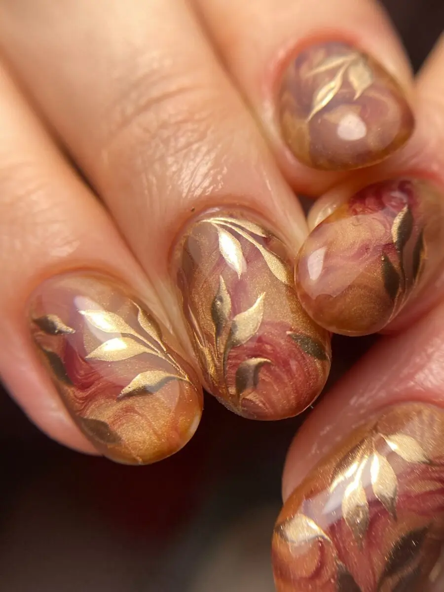 Elegant autumn leaves on golden base nails